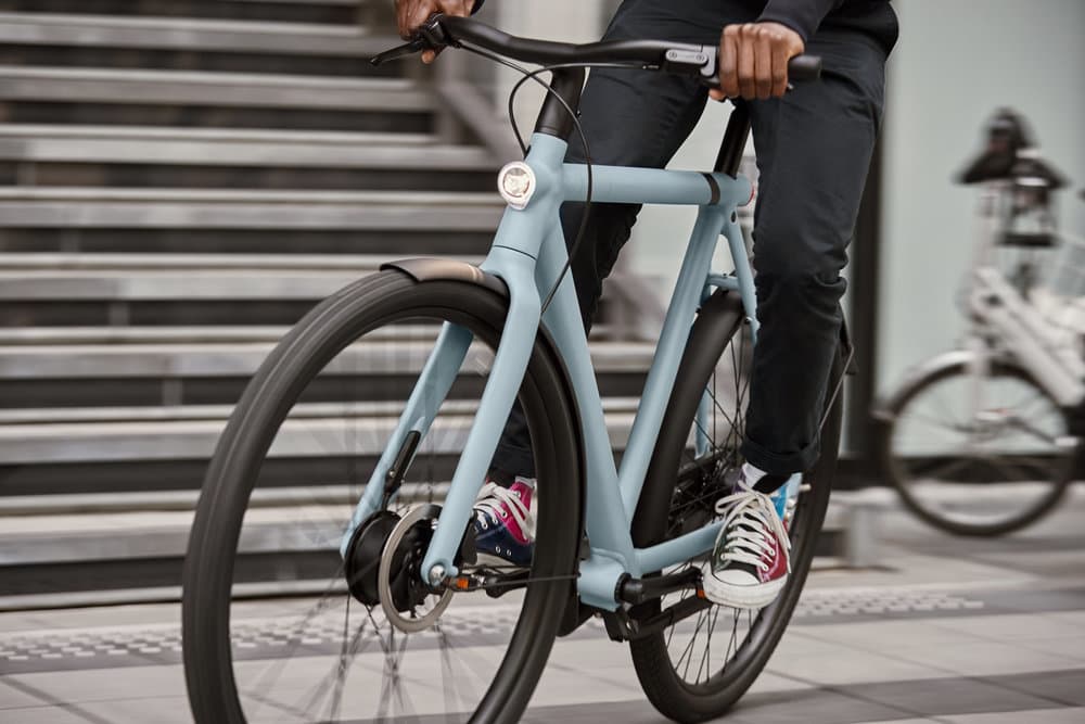 Close-up of a rider on a blue electric bicycle